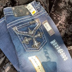 With tags.  Miss Me skinny jeans. Mid-rise, Skinny size 30.